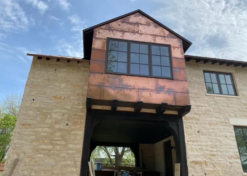 Copper metal panel facade on a stone building for Skylight Installation in Poplar Grove